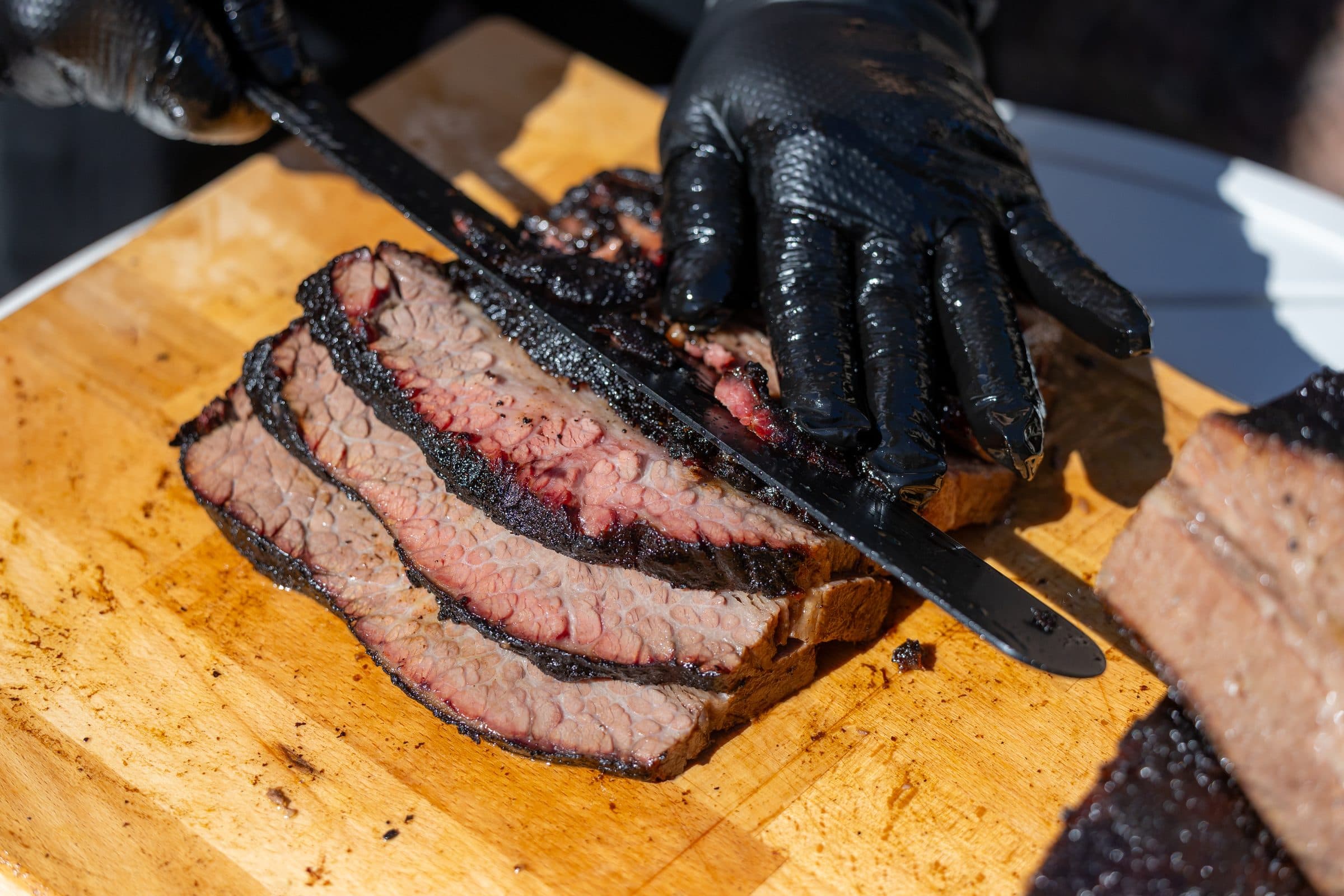 Slicing a 42-hour brisket on a cutting board