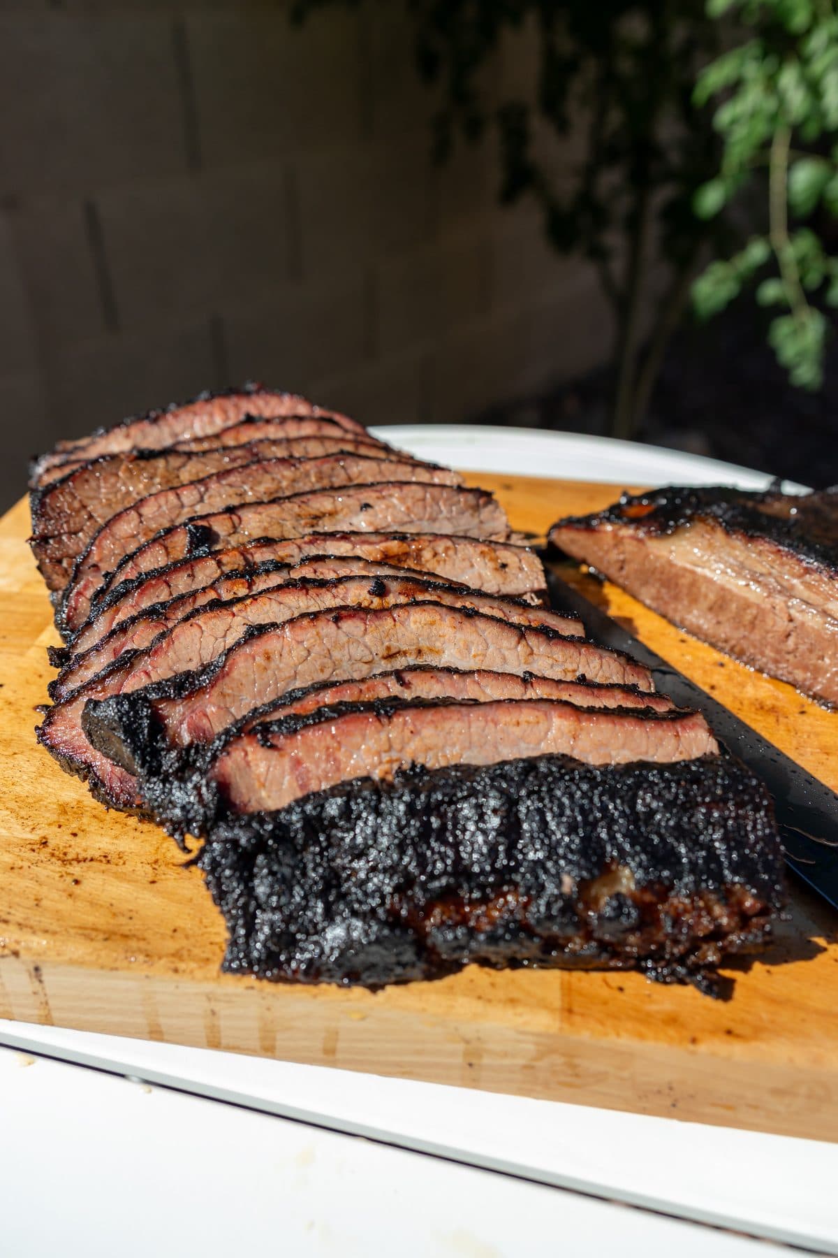 Sliced 42-hour brisket fanned out on a cutting board